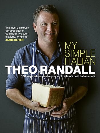 Chef Theo Randall holding a block of cheese, promoting his cookbook 
